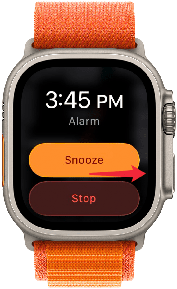 a screenshot of an alarm going off on apple watch with a red arrow pointing at the side button