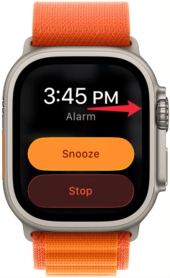 a screenshot of an alarm going off on apple watch with a red arrow pointing at the digital crown