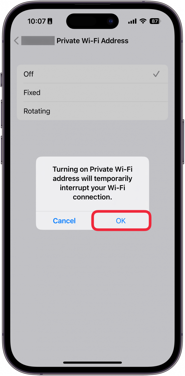 iphone wi-fi privacy settings displaying a pop up that the device will be disconnected from wi-fi for a moment with a red box around ok