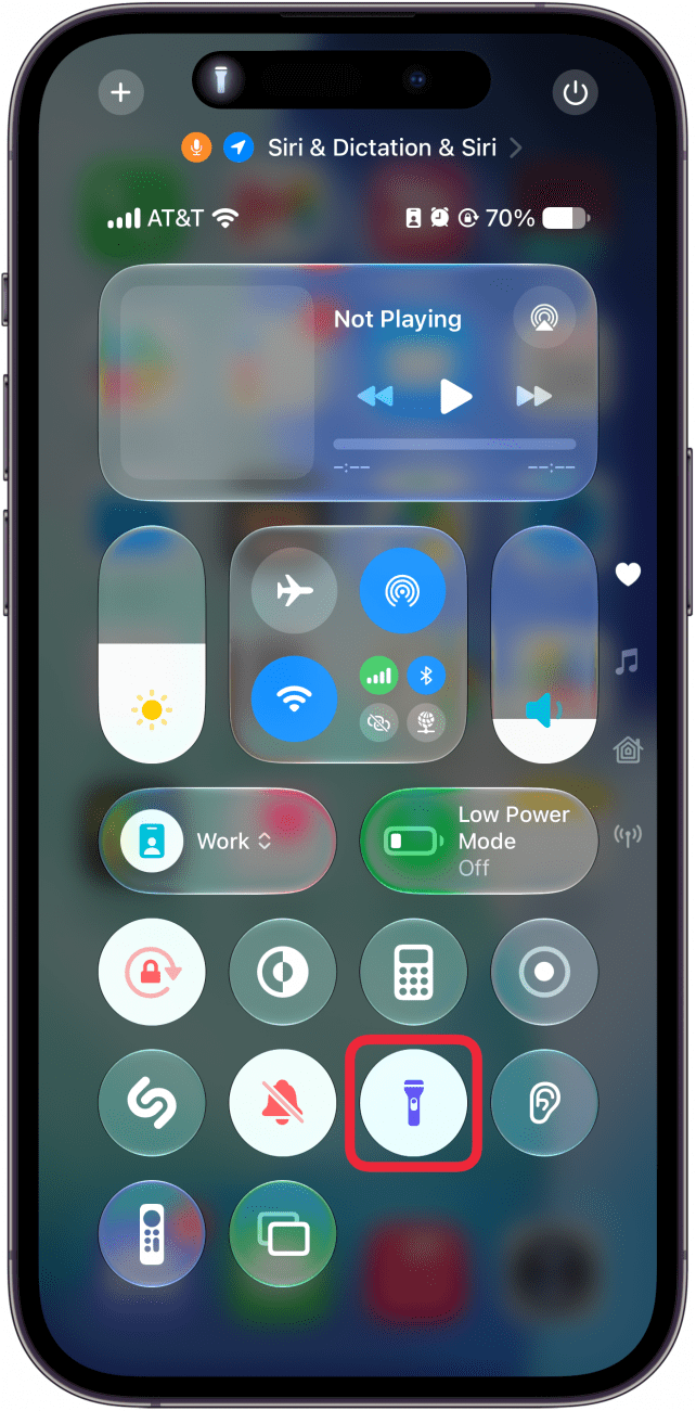 a screenshot of the iphone control center with a red box around flashlight icon, which is now white