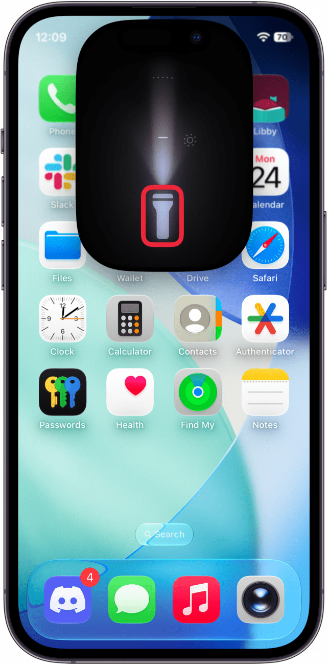a screenshot of the iphone home screen displaying the flashlight UI and a red box around the flashlight icon