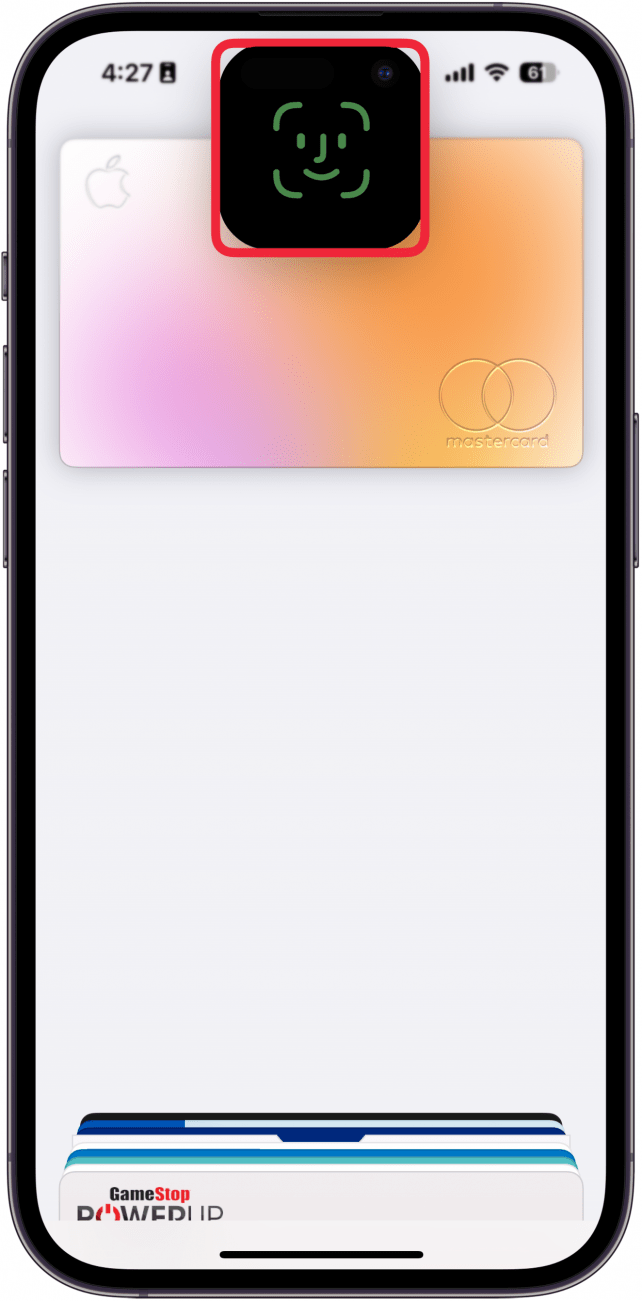 a screenshot of apple pay on the iphone lock screen with a red box around the face id prompt