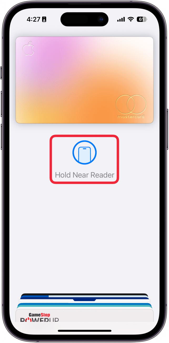 a screenshot of apple pay on the iphone lock screen with a red box around prompt to hold the device to the card reader