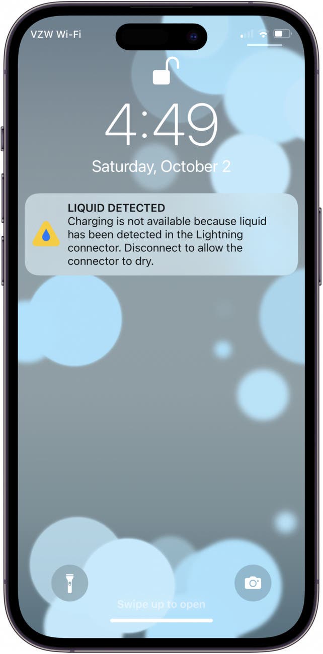 a screenshot of an iphone lock screen with a notification that says liquid has been detected in the charging port