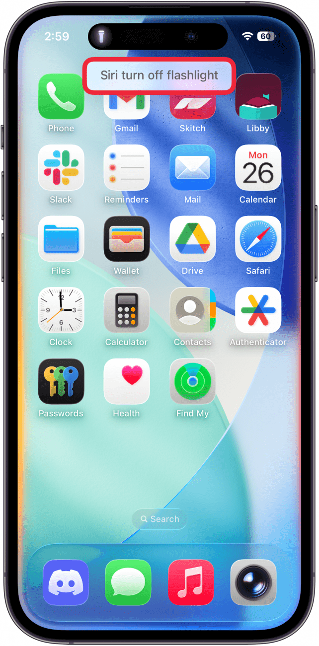 a screenshot of the iphone home screen displaying an active siri prompt that reads "turn the flashlight off"