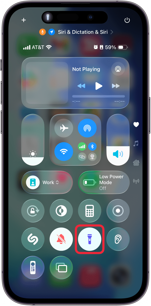 a screenshot of the iphone control center with a red box around flashlight icon, which is now white
