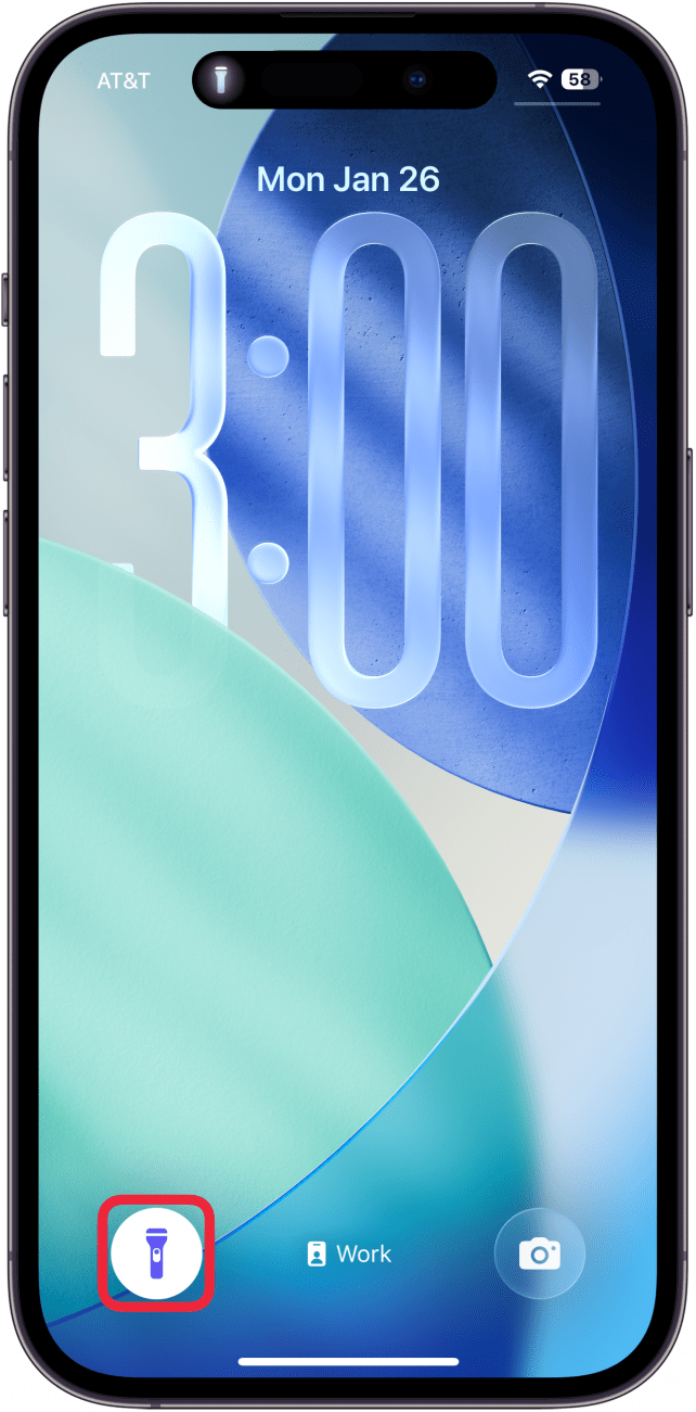 a screenshot of the iphone lock screen with a red box around the flashlight icon in the lower right which is white, indicating that the flashlight is turned on