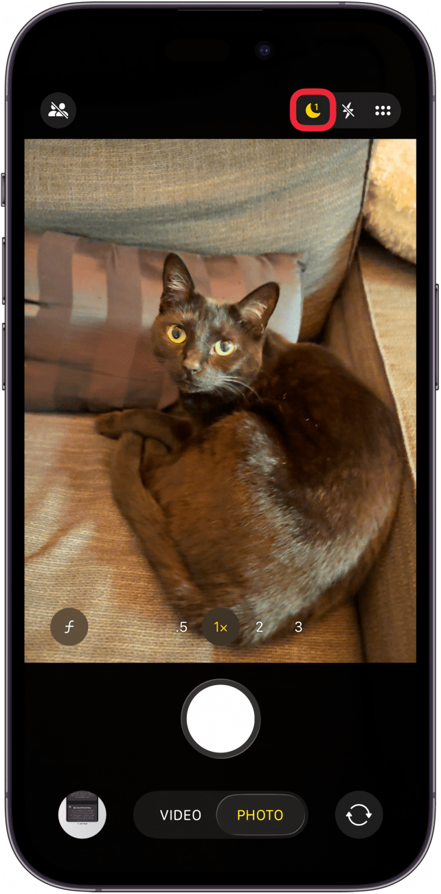 a screenshot of the camera app on the iphone with a red box around the night mode icon, which is yellow