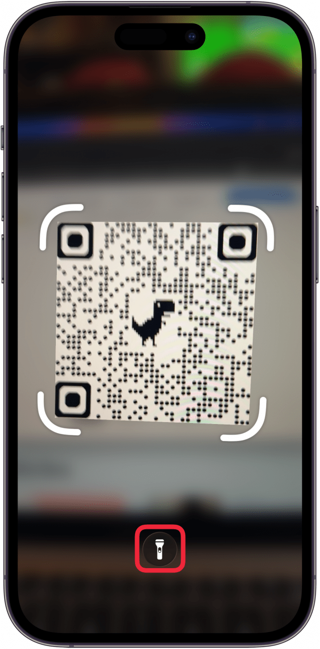 a screenshot of the code scanner app on iphone with a red box around the flashlight icon