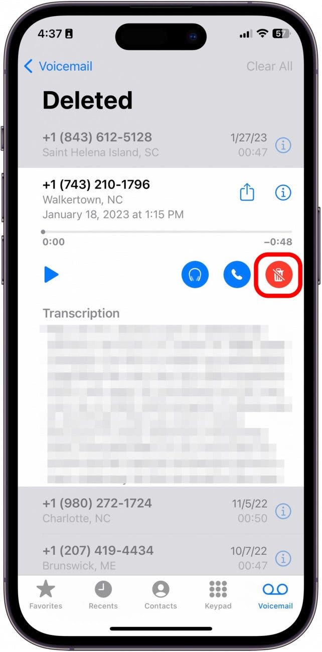 Tap the red trashcan with a slash through it. The message will automatically be moved back into your main Voicemail box.