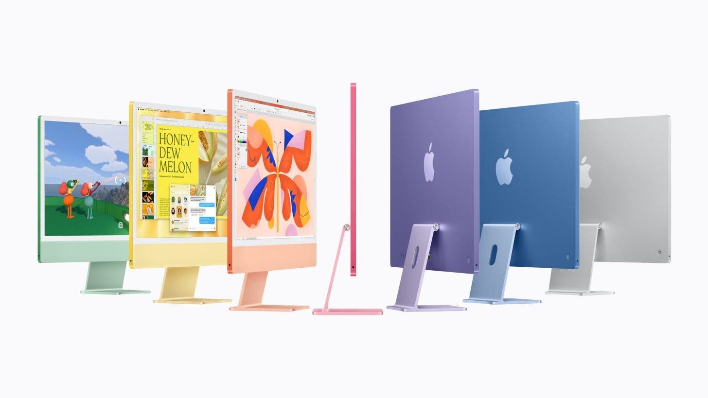 an image of seven imacs lines up in different colors; from left to right: green, yellow, orange, pink, purple, blue, and silver