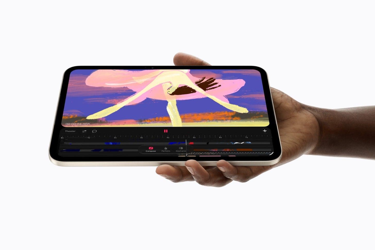 an image of a hand holding an ipad mini with procreate open