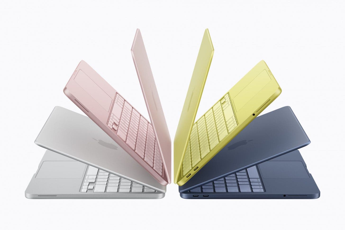 an image showing all of the colors of the new macbook neo. from left to right: silver, blush, citrus, and indigo