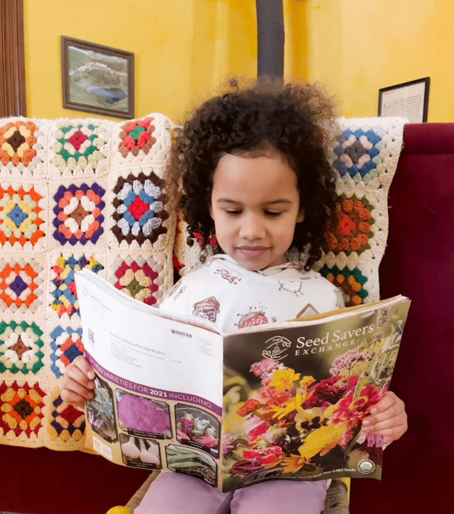 photo of a little girl reading a seed catalog
