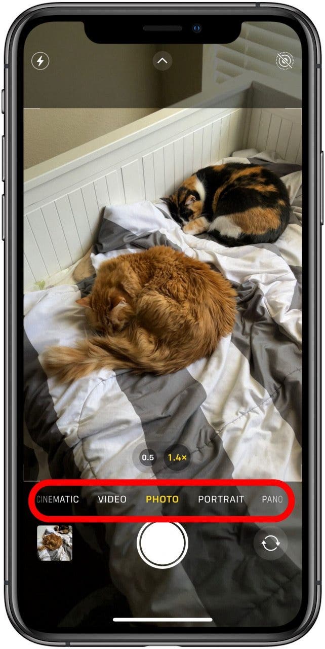 Camera app in Photo mode with the Mode menu below the viewfinder marked.