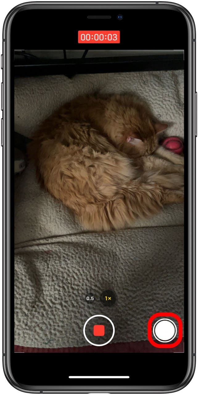 Camera app in Video mode while video is recording with the camera shutter button marked.